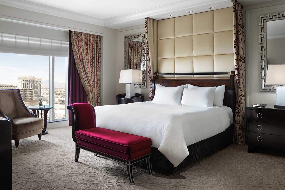 A hotel room with a king bed and a view of the Las Vegas valley.