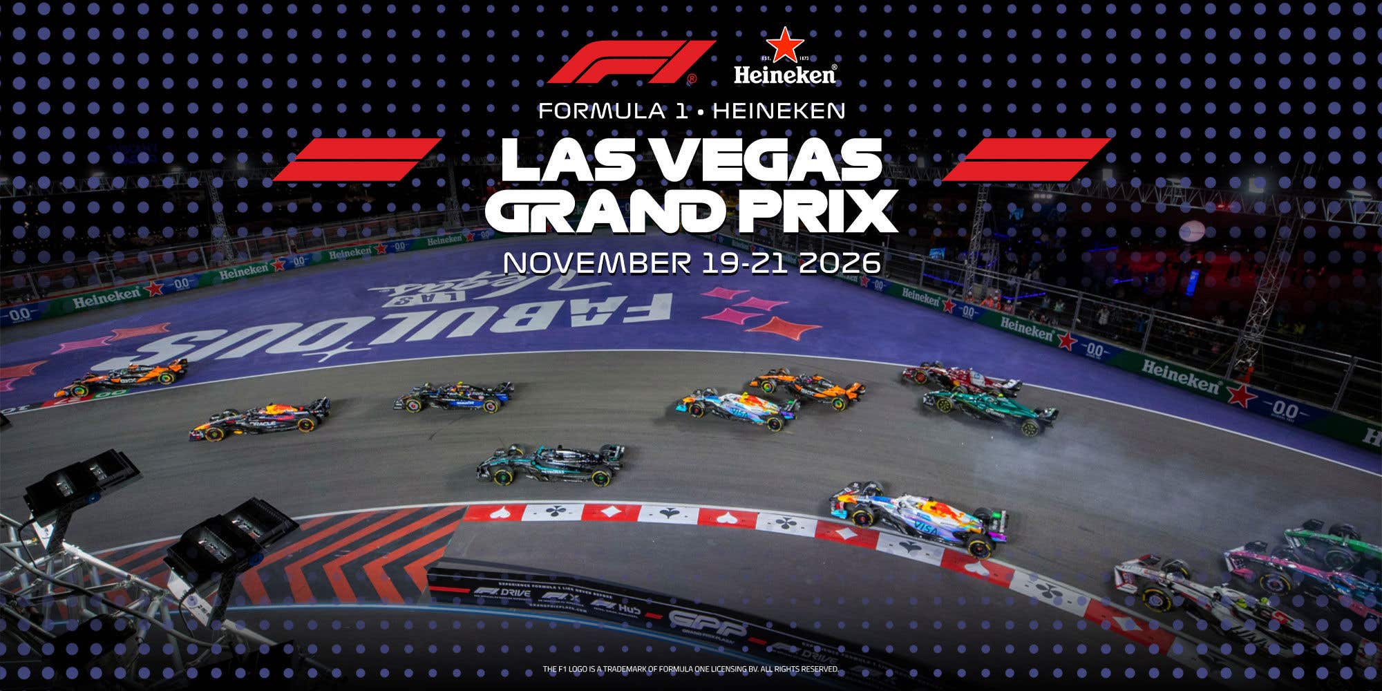 Formula 1 cars race through a nighttime Las Vegas street circuit during the FORMULA 1 HEINEKEN LAS VEGAS GRAND PRIX, with event branding visible on the track and screens.