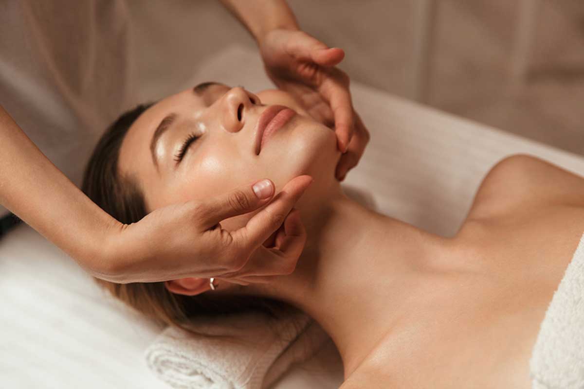 A woman receives a facial.